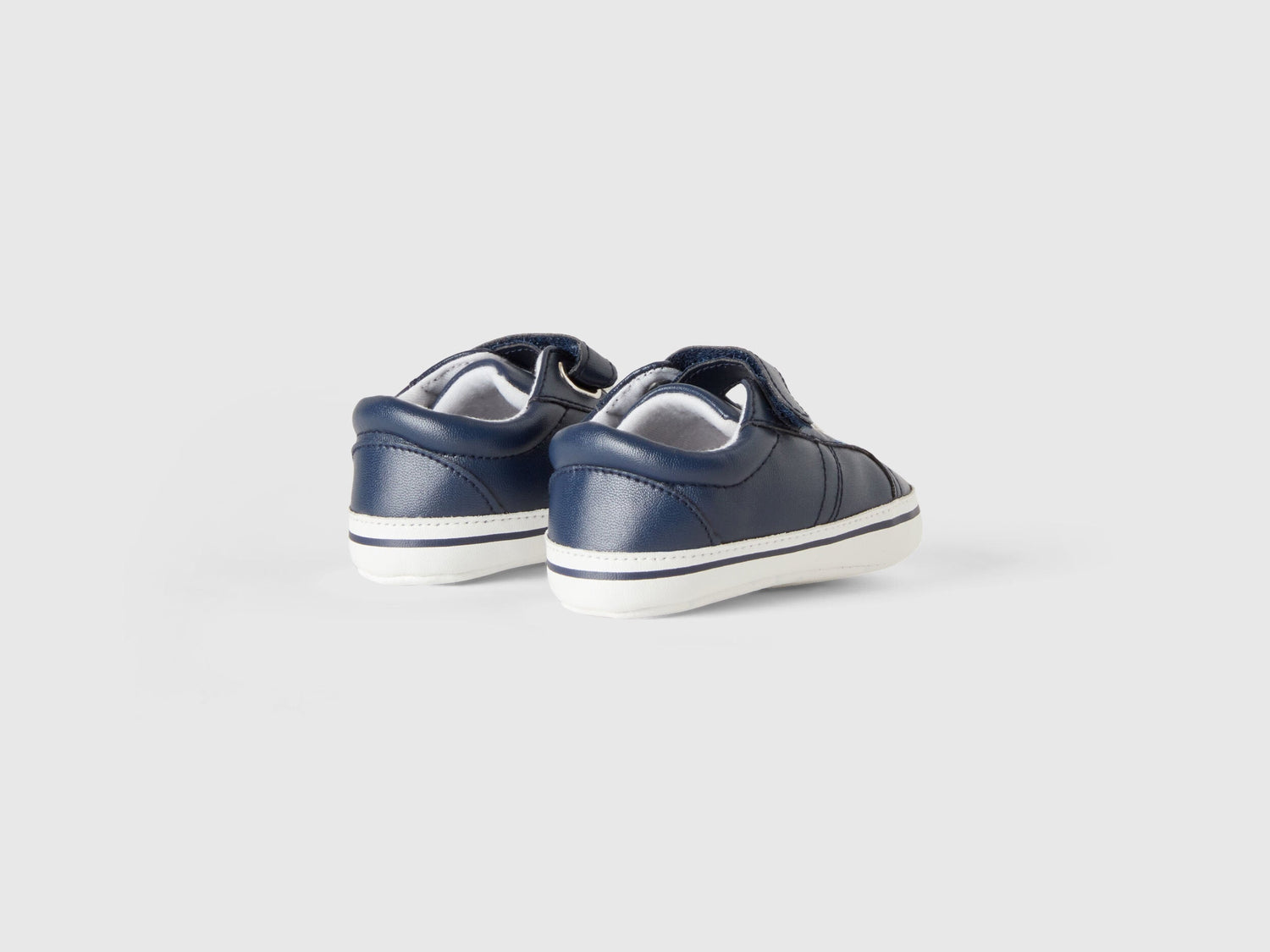Back view of a pair of first-step kids shoes with white soles, showing the stable design for active toddlers in Kuwait.