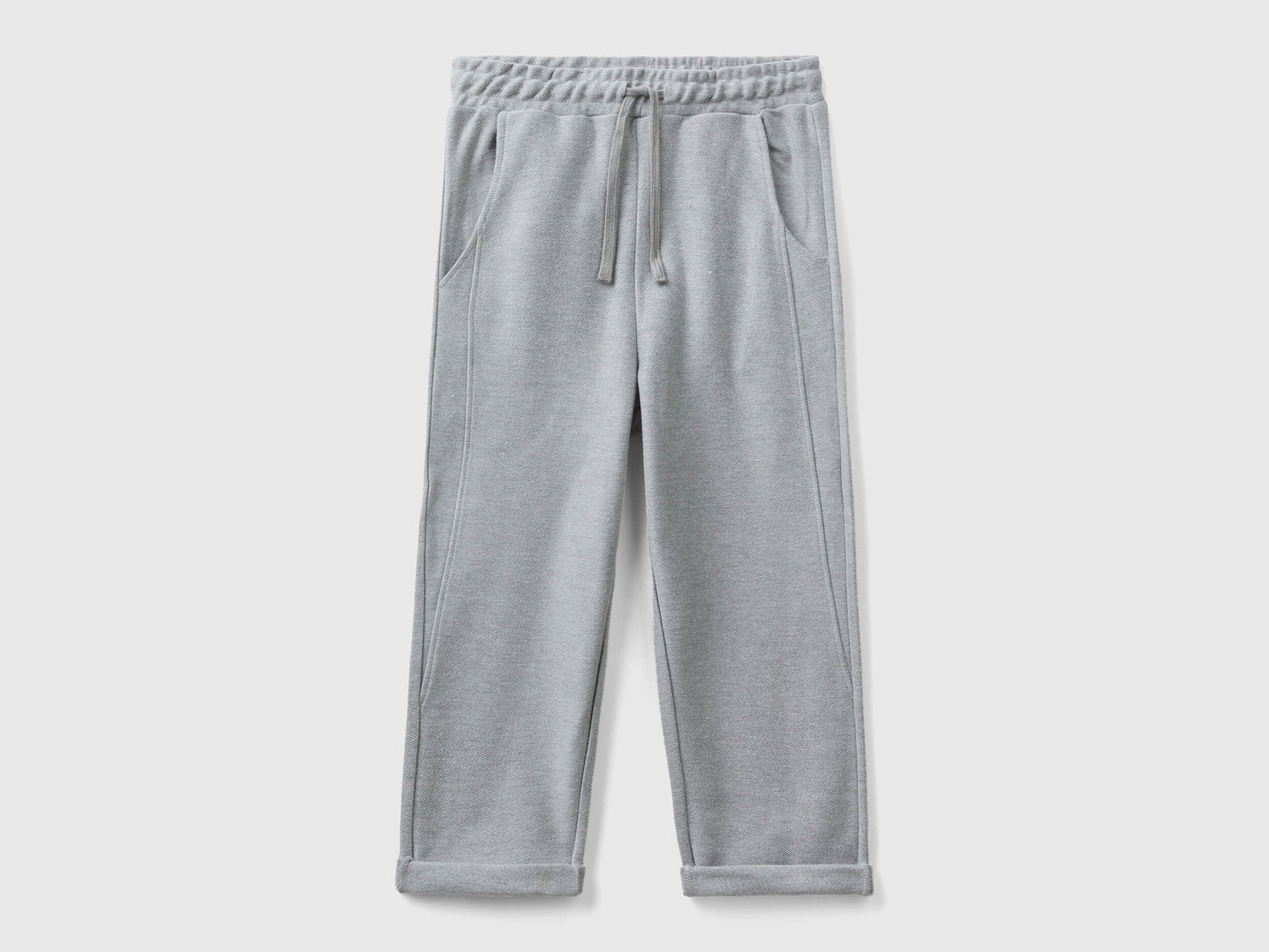 Front view of grey carrot fit joggers with a drawstring waist.