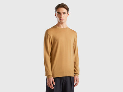 Front view of a man wearing a plain beige sweater.