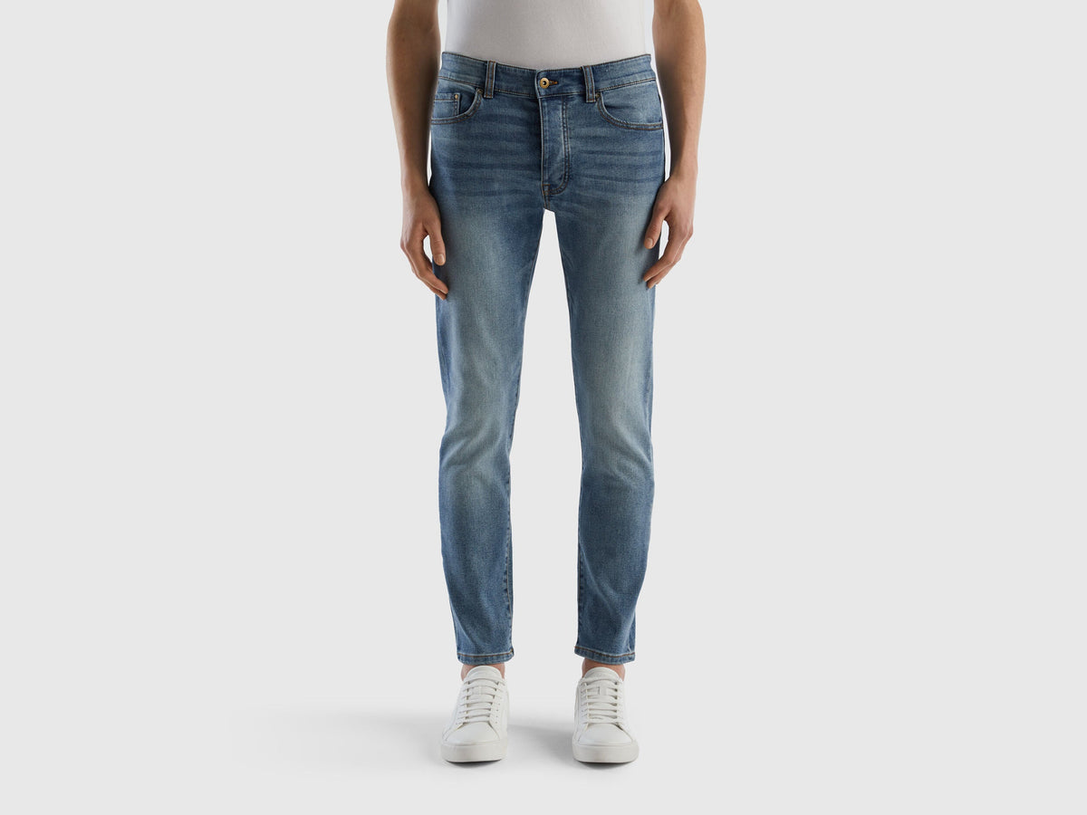 Back view of a man wearing black slim-fit jeans.