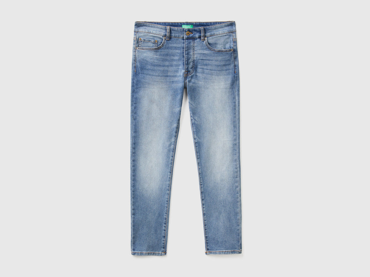 Flat lay back view of black slim-fit jeans for men.