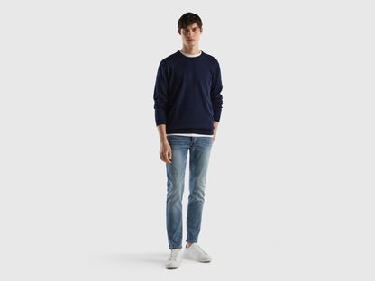 Front view of a man wearing black slim-fit jeans.