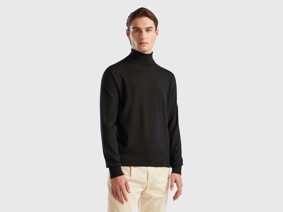 Front view of a man wearing a black turtleneck sweater.