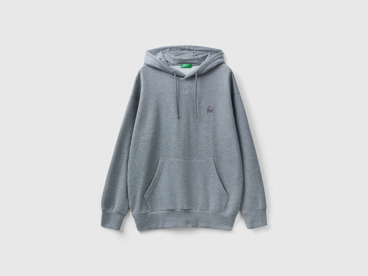 Side view of a man wearing a plain grey hoodie.