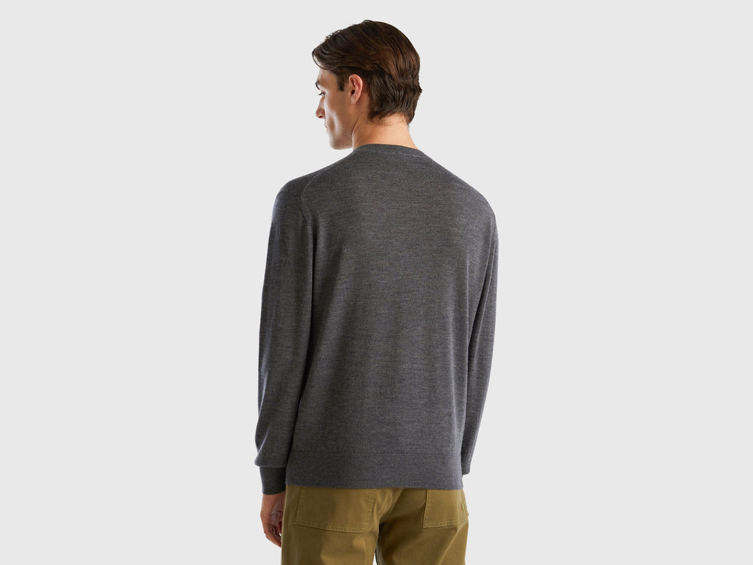 Back view of a man wearing a grey merino wool sweater.