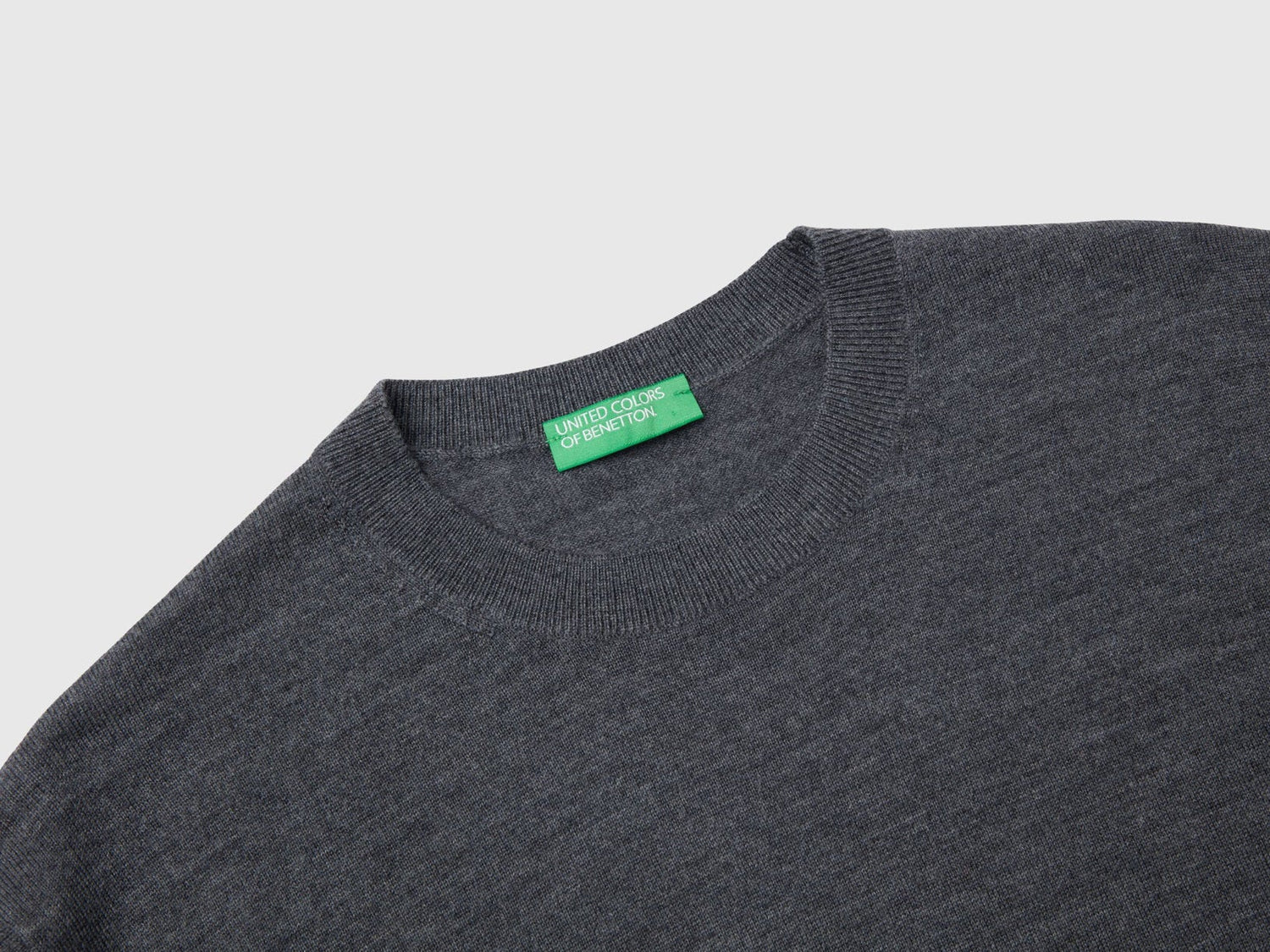 Close-up of the collar and texture of a grey merino wool sweater for men.