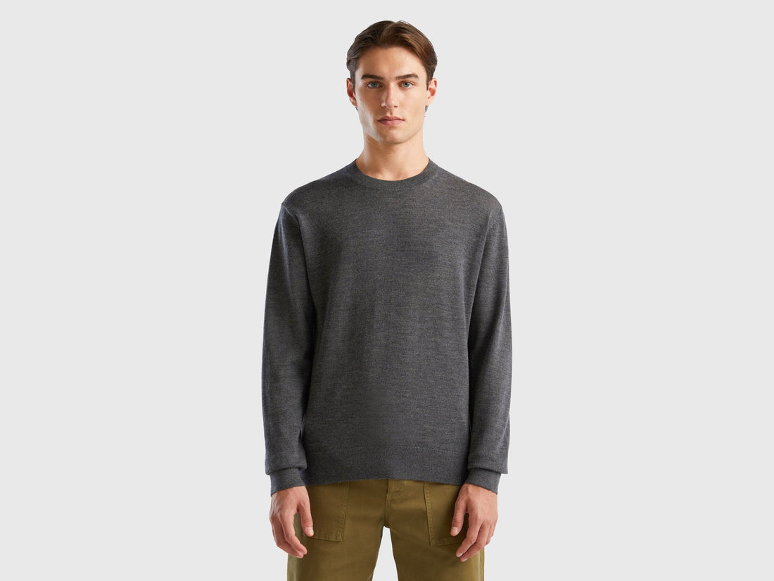 Front view of a man wearing a grey merino wool sweater.