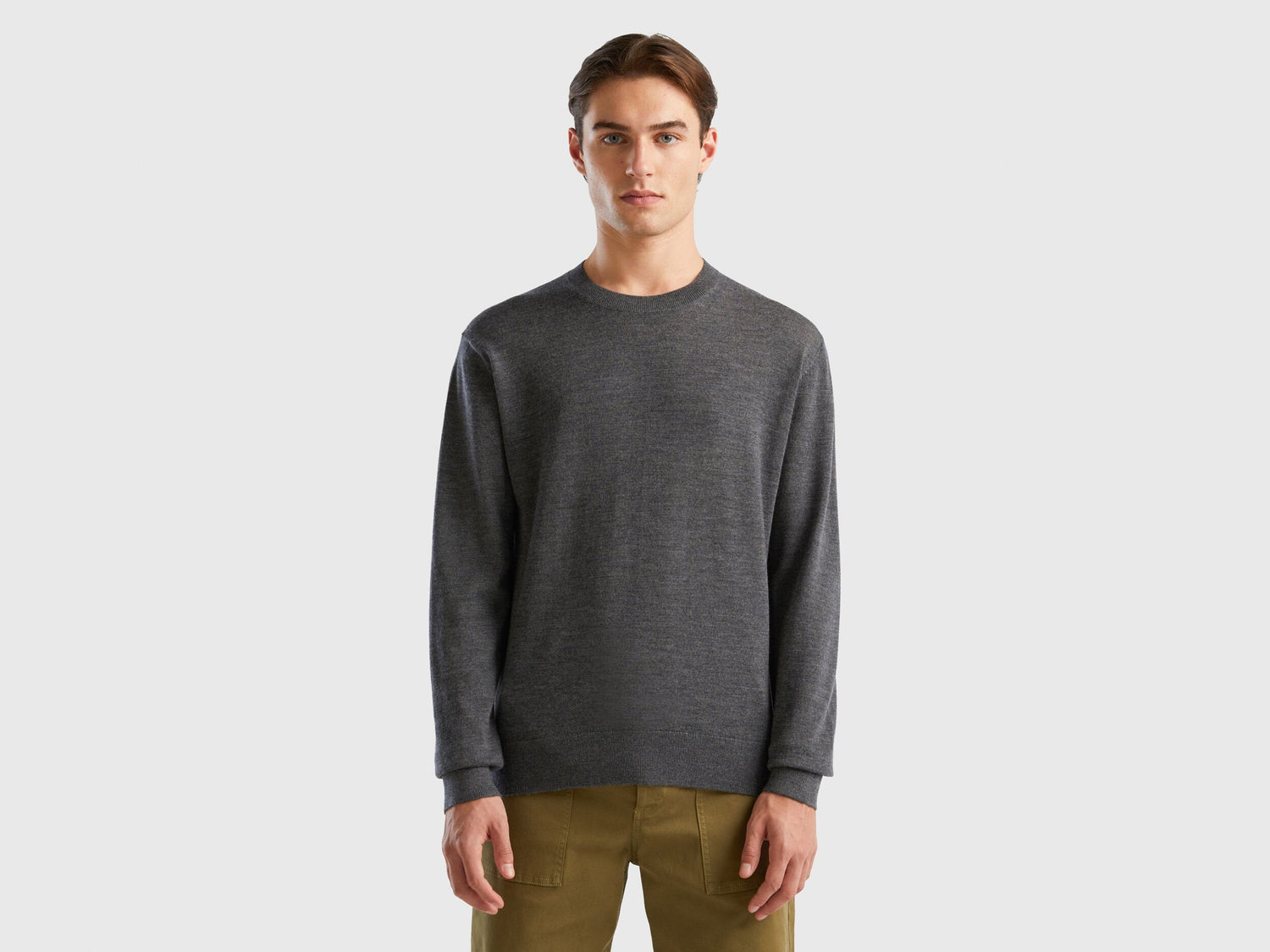 Front view of a man wearing a grey merino wool sweater.