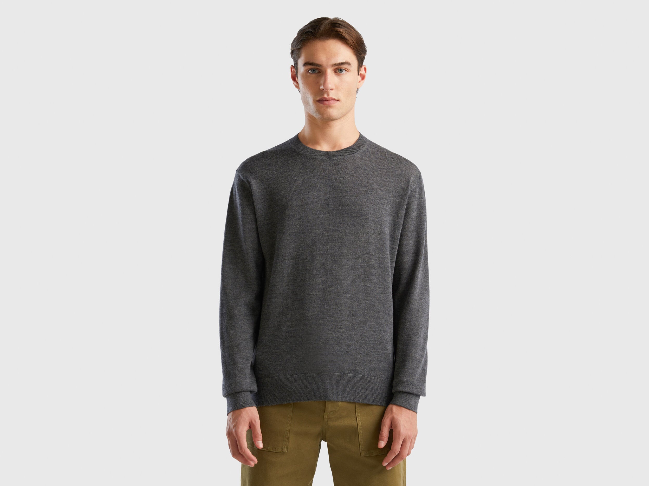 Front view of a man wearing a grey merino wool sweater.
