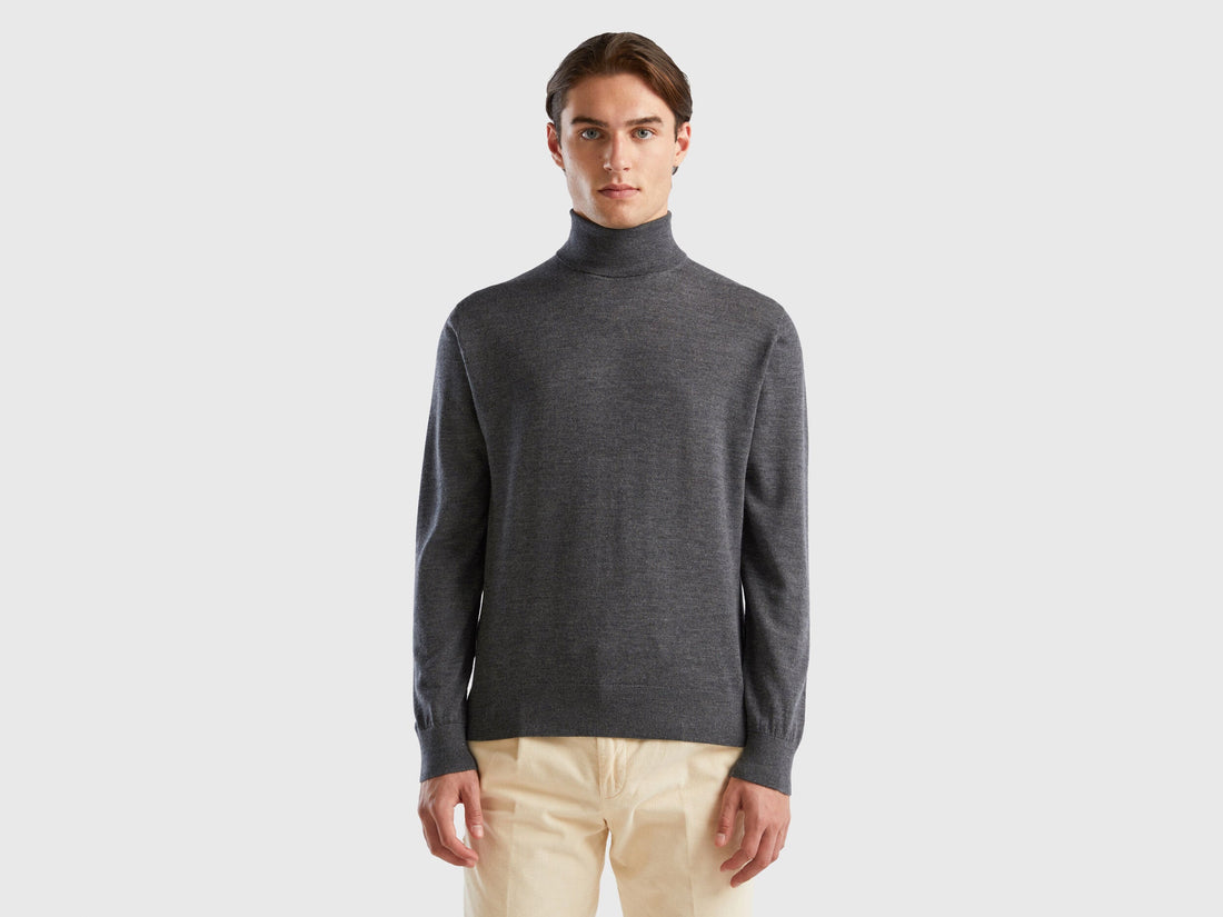 Front view of a man wearing a grey turtleneck sweater.

