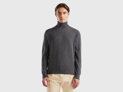 Front view of a man wearing a grey turtleneck sweater.

