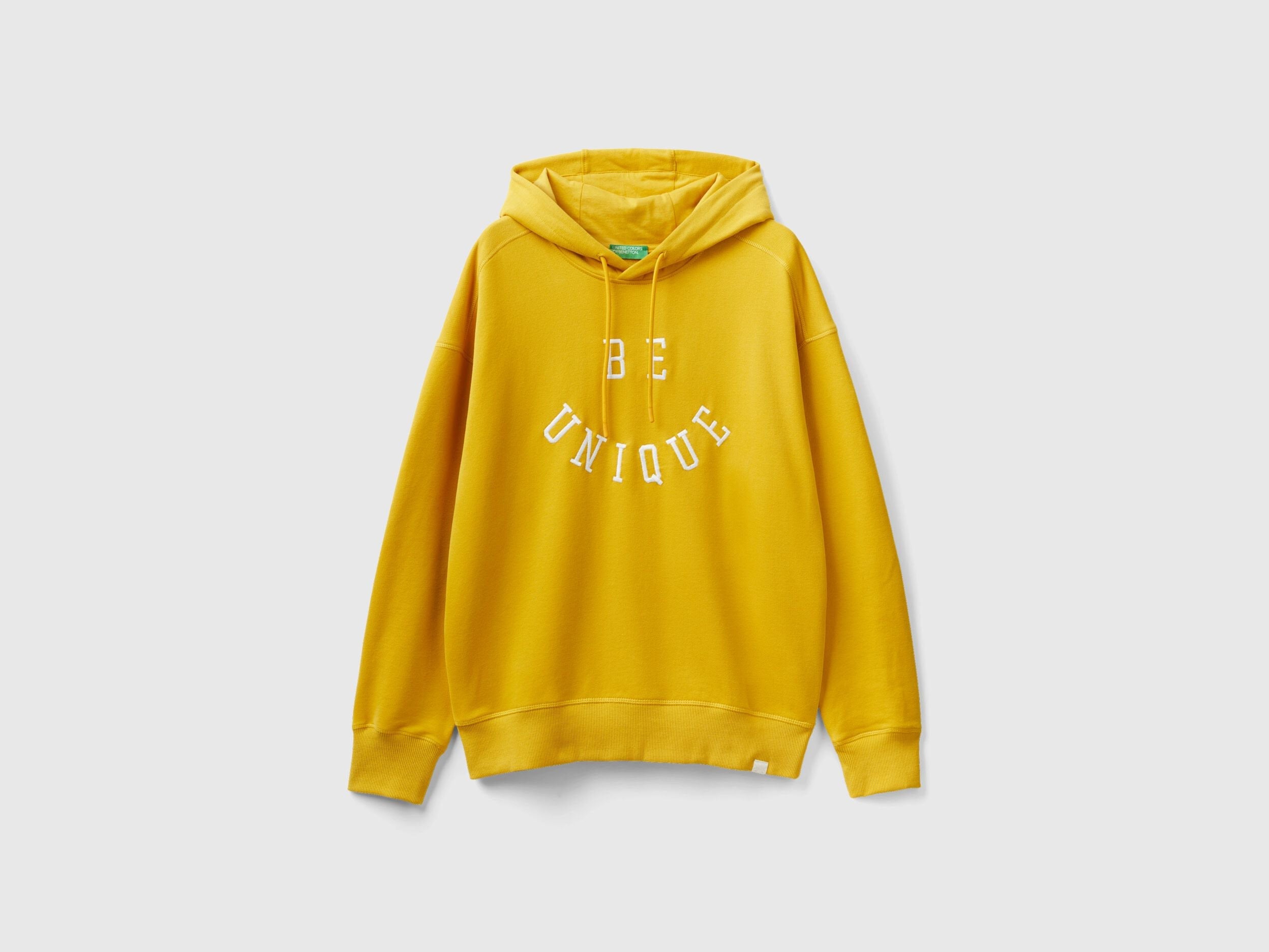 Flat lay back view of a yellow hoodie for men with a graphic print.