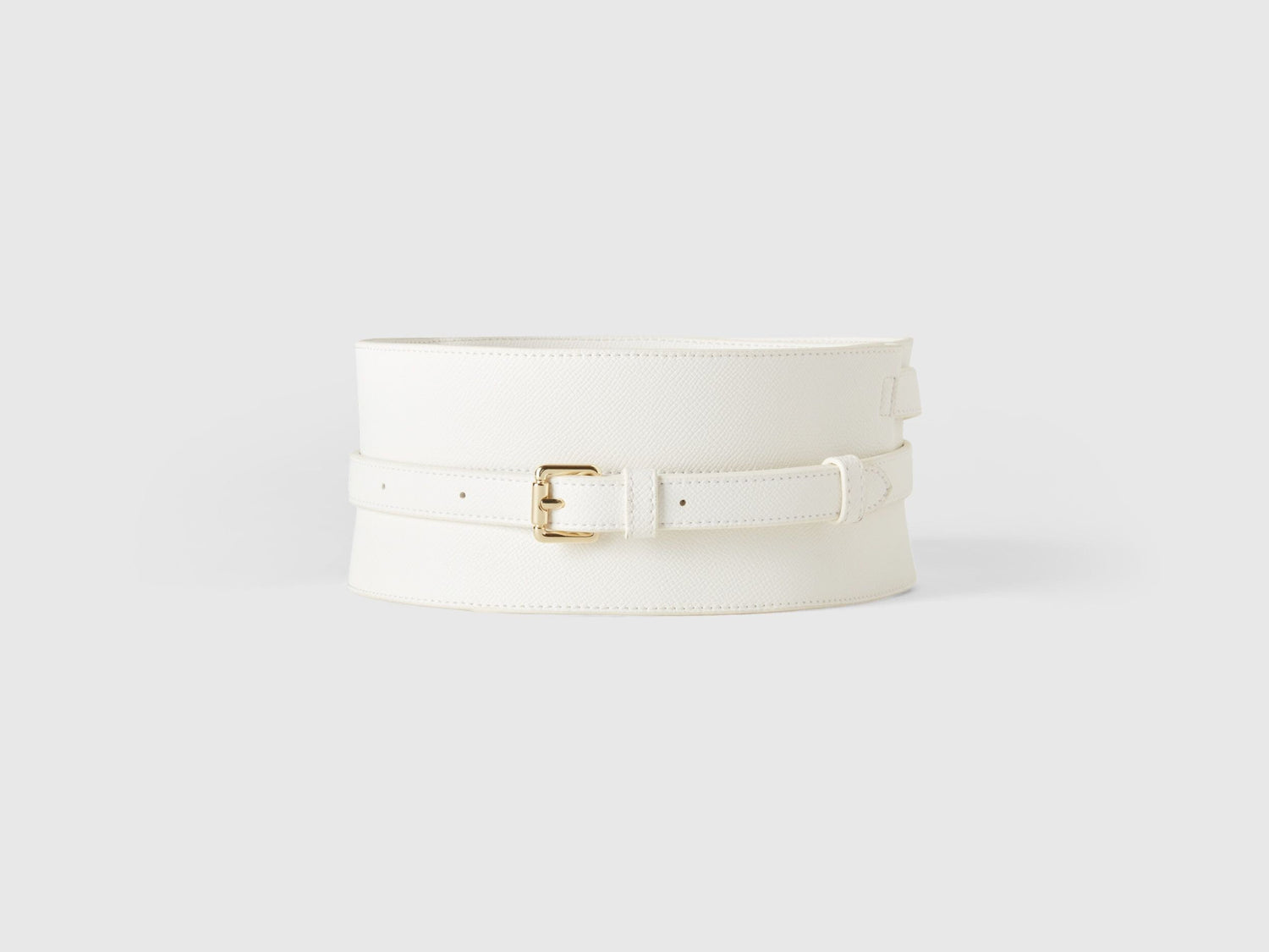 Front view of a wide white crocodile print corset belt with a gold buckle. Fashion accessory.
