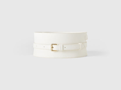 Front view of a wide white crocodile print corset belt with a gold buckle. Fashion accessory.